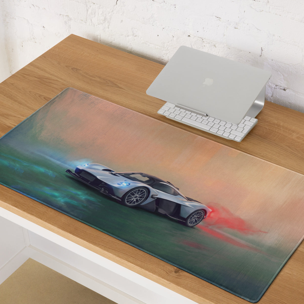 Aston Martin Valkyrie inspired aero edition desk mat featuring a silver and black sports car graphic with teal and red accents