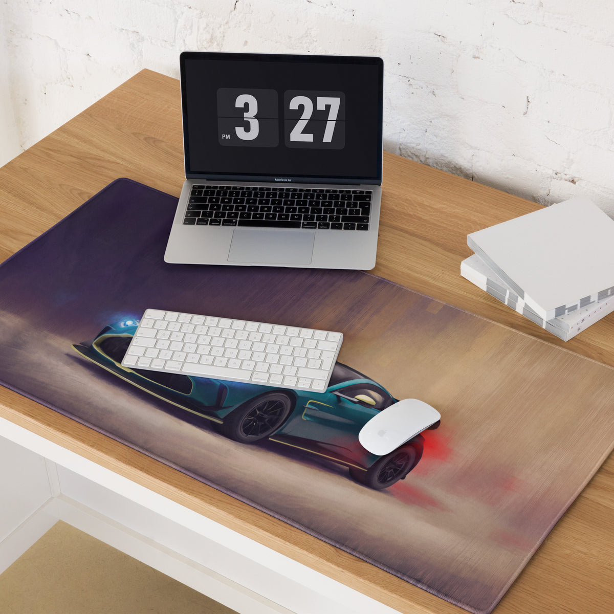 A dark teal aston martin vantage inspired racing car graphic on a non slip rubber desk pad with brown gray accents