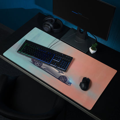 A sleek rectangular gaming mousepad with a gradient light blue to soft peach background and a silver lamborghini huracán print