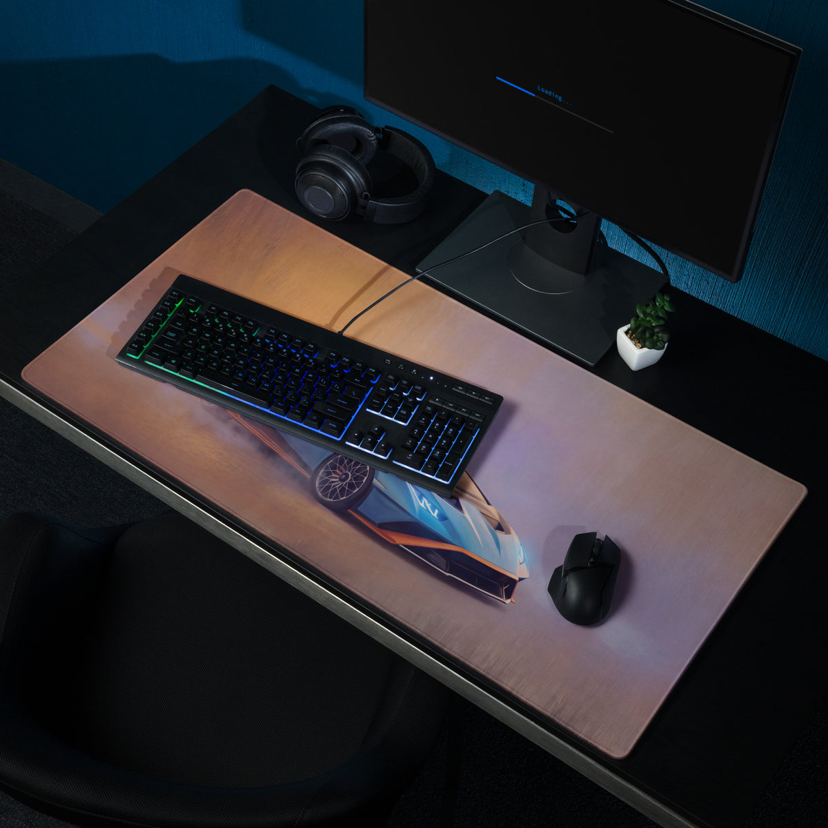 A sleek rectangular extended non slip gaming mousepad with a vibrant blue and orange futuristic car graphic