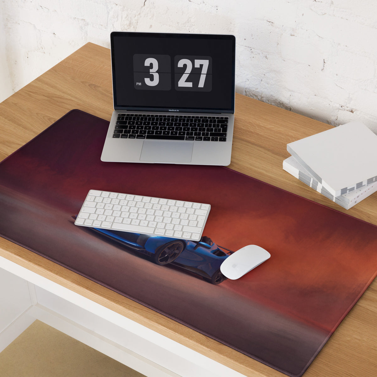 A dark red leather rectangular desk mat with a blue Ferrari SF90 XX corsa car on an orange gradient background