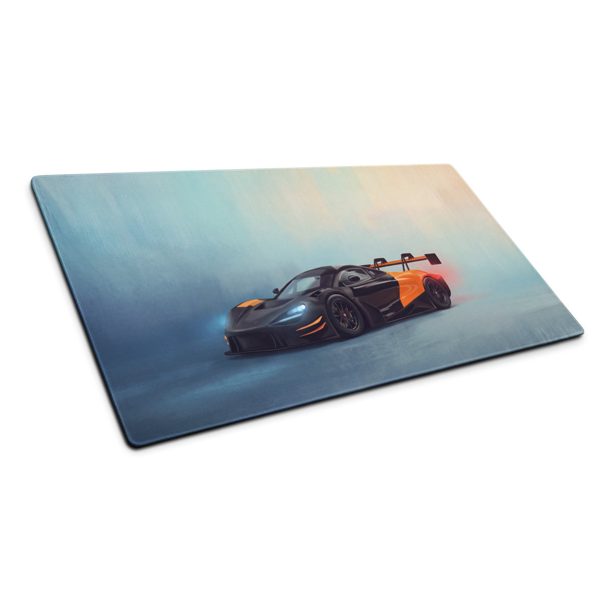Rectangular cloth desk mat featuring a vibrant black and orange McLaren 720S GT3 sports car on a blue teal gradient background