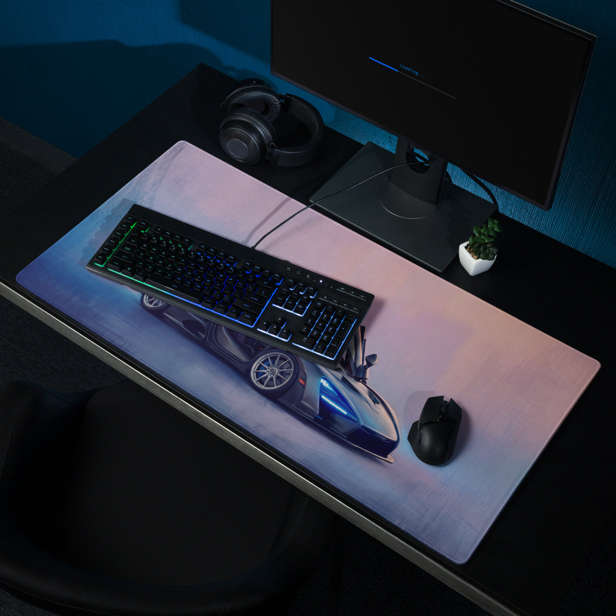 A sleek rectangular low-friction cloth gaming mousepad with a blue and silver mclaren senna sports car graphic