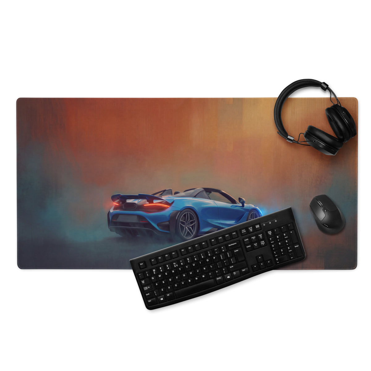 Blue sports car graphic on mclaren 765lt inspired curacao blue convertible xl gaming mousepad with keyboard and headphones