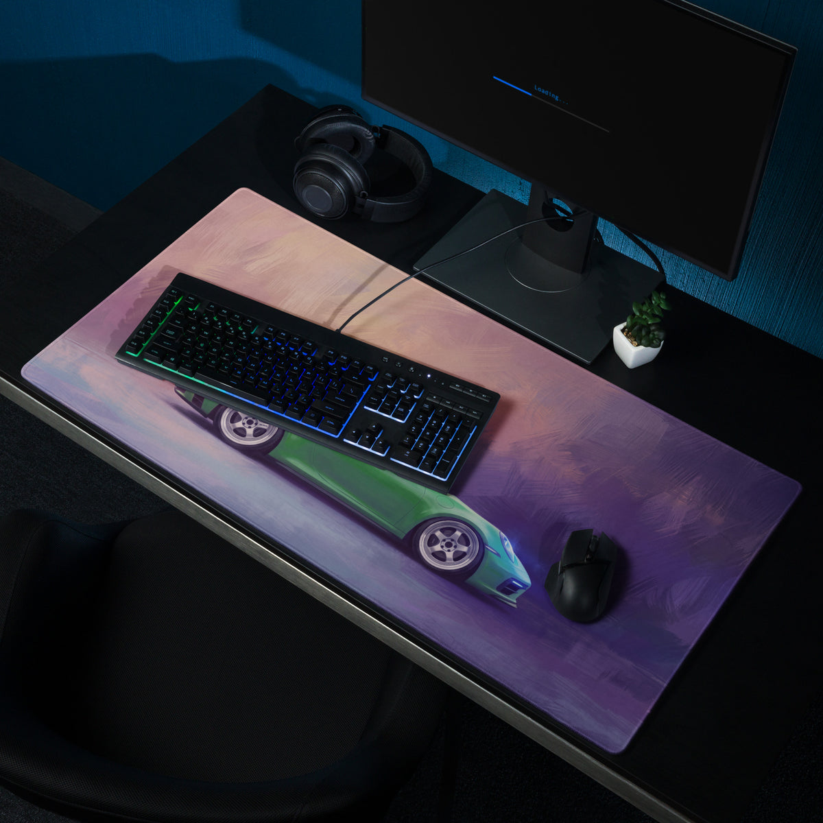 A rectangular low-friction cloth gaming mousepad with a vibrant green Porsche 911 GT3 sports car and purple pink sky design
