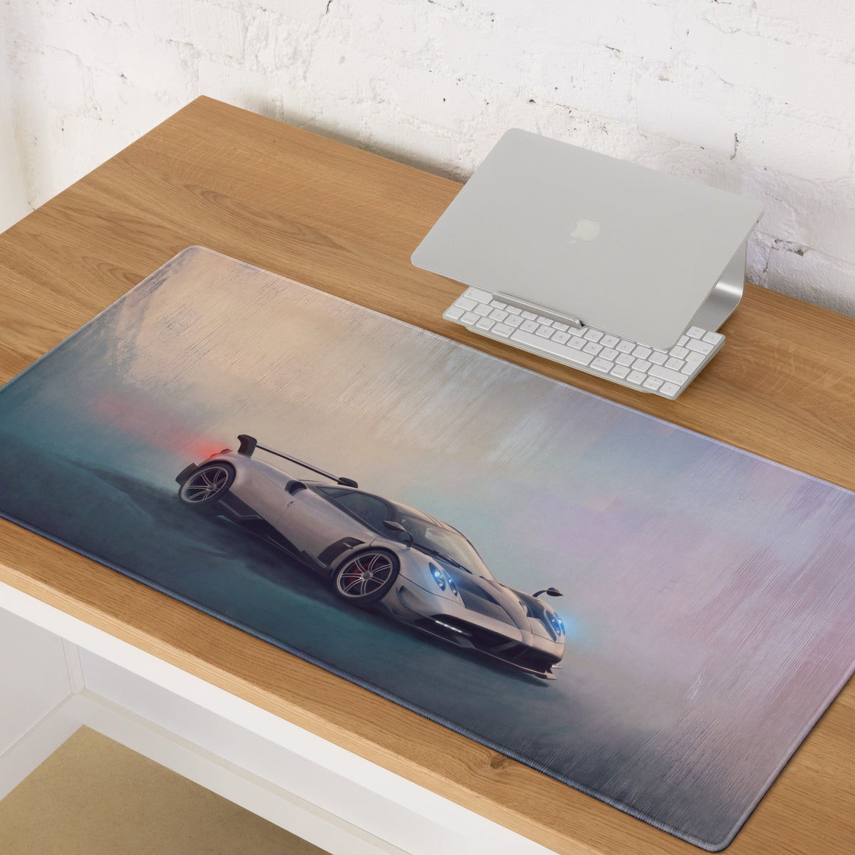 A sleek rectangular non-slip silver Pagani Huayra inspired extended desk pad with a high-resolution sports car print