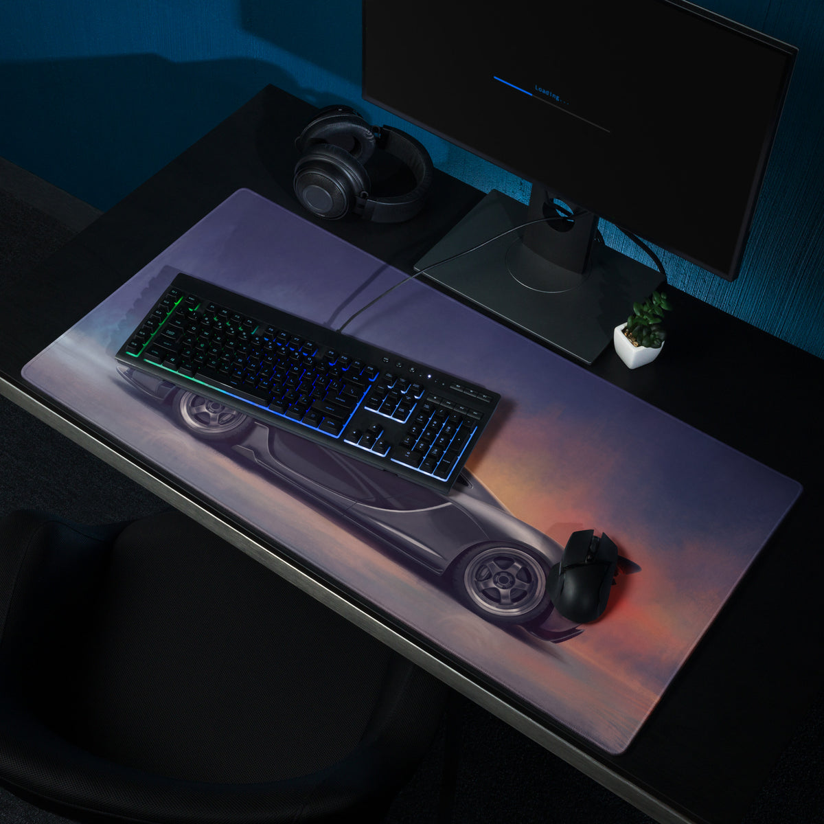 A sleek charcoal McLaren P1 inspired XL gaming mousepad with a silver sports car and glowing orange purple accents