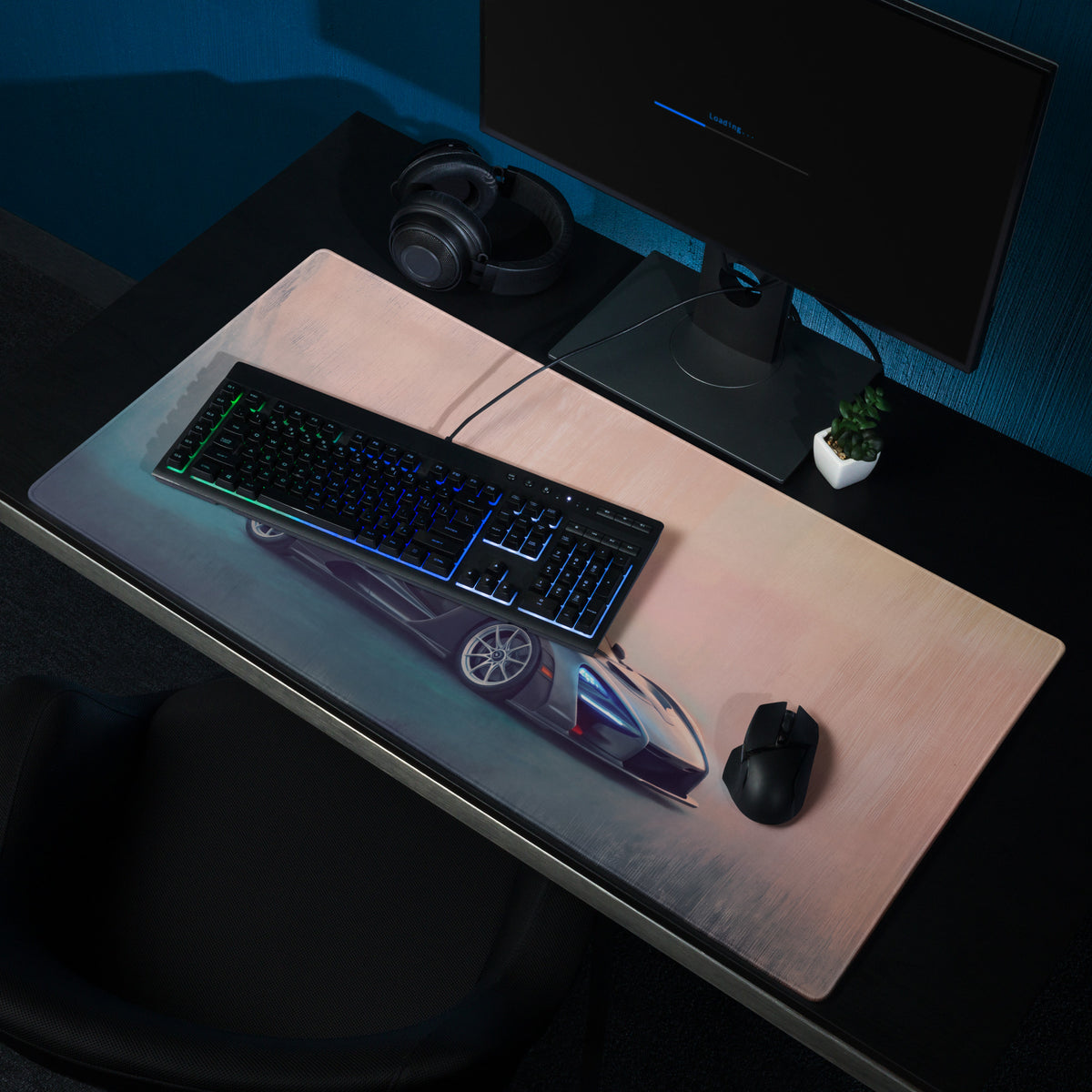A sleek rectangular xl gaming mousepad with a futuristic blue and silver McLaren Senna inspired sports car graphic