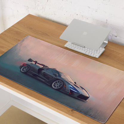 A sleek dark gray mclaren senna racing car graphic printed on a soft pink and teal gradient xl gaming mousepad