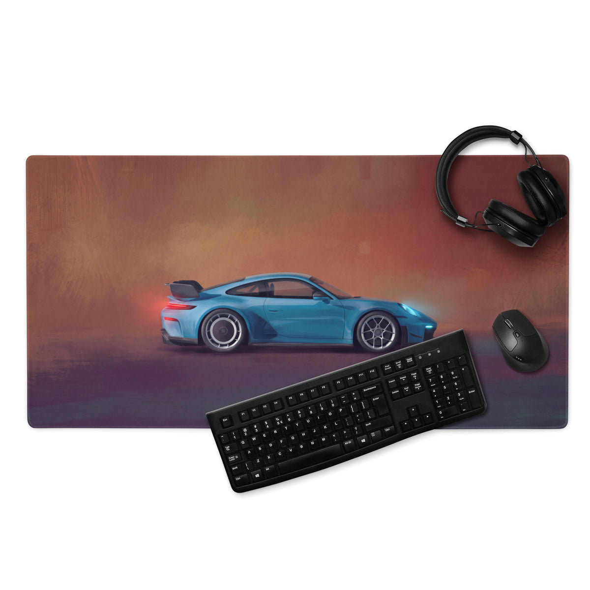 Blue sports car graphic on a stitched edge miami blue porsche 911 gt3 inspired desk pad with black keyboard and mouse nearby