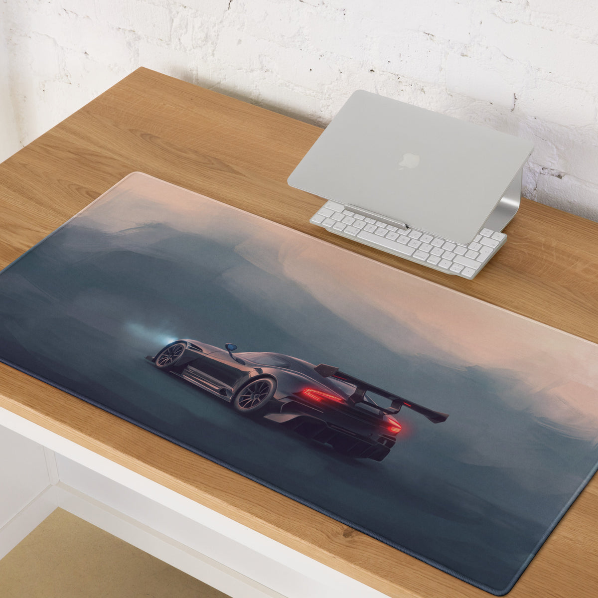 A sleek dark gray racing car with glowing red taillights on an aston martin vulcan inspired onyx track desk mat