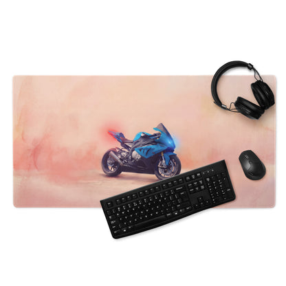 Blue motorcycle graphic on a pink watercolor style waterproof large mouse pad for racing desk accessory use