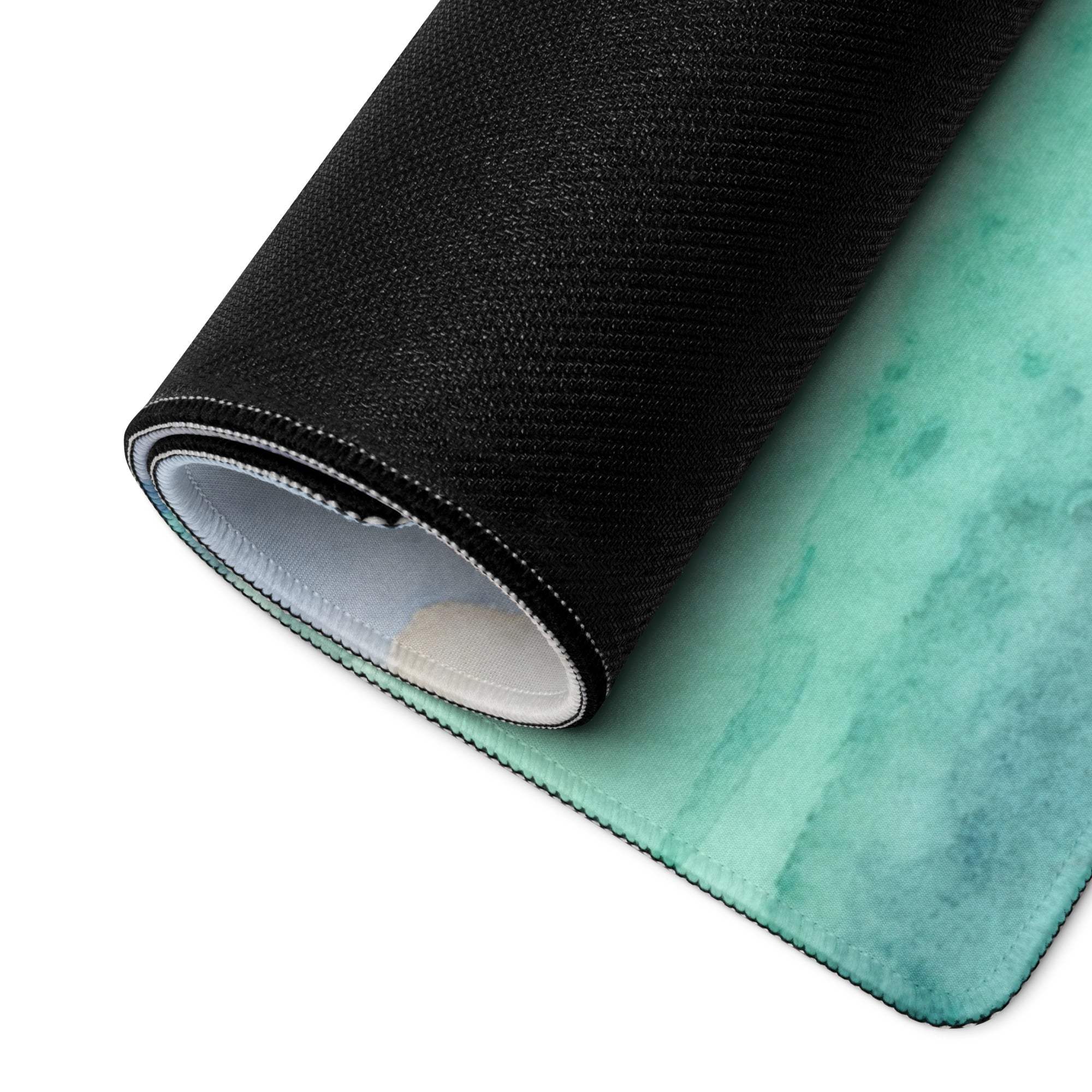 Rolled watercolor tropical island gaming mouse pad with teal gradient and non-slip backing