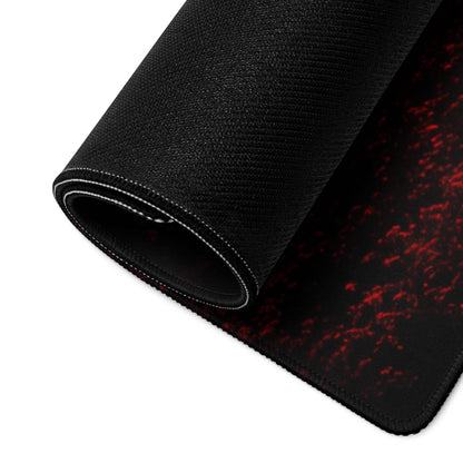 Black gaming mousepad with red splatter texture and non-slip backing