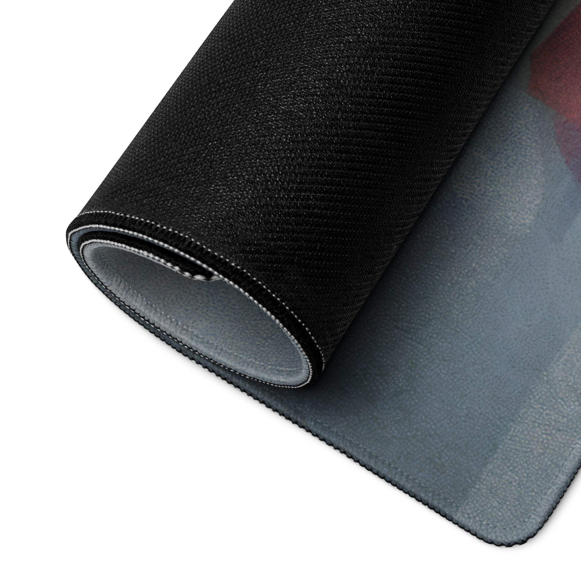 Back of large abstract landscape gaming mouse pad with black textured top, gray underside and stitched edges