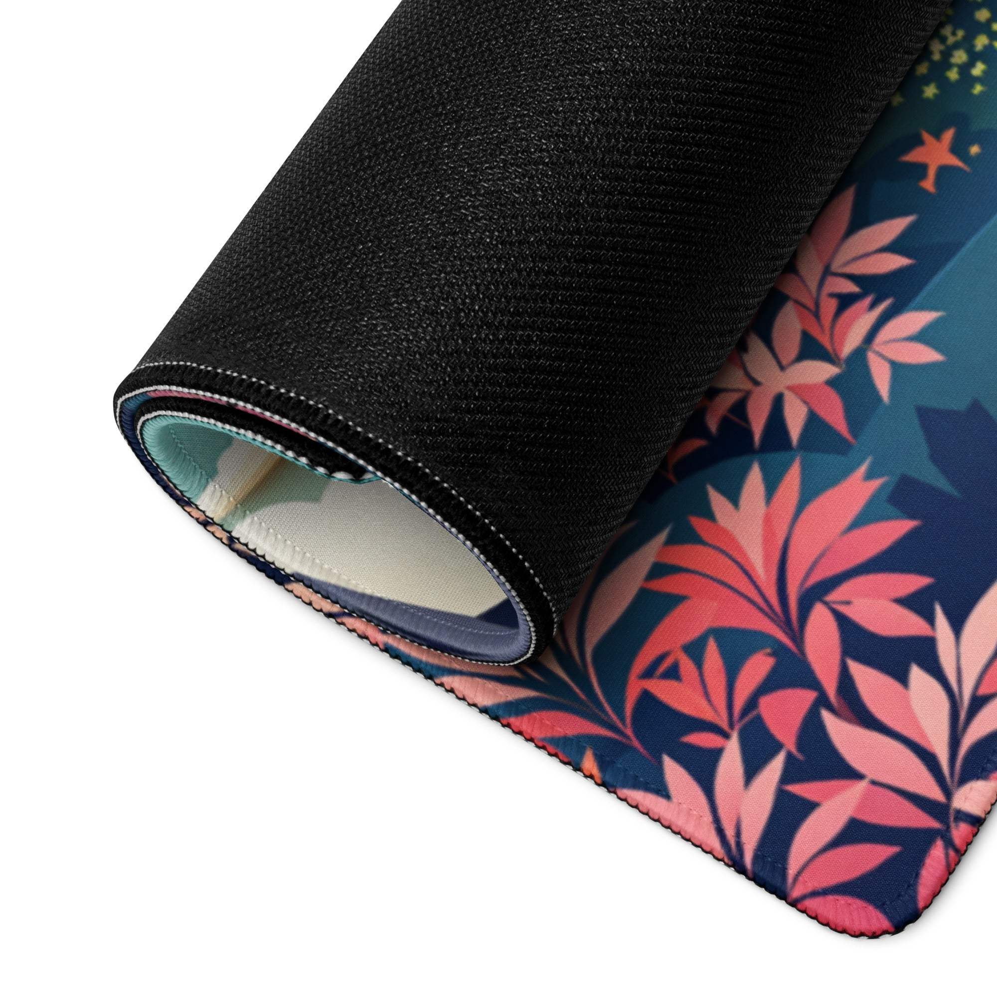 Rolled-up artistic floral gaming mouse pad with pink coral leaves on blue