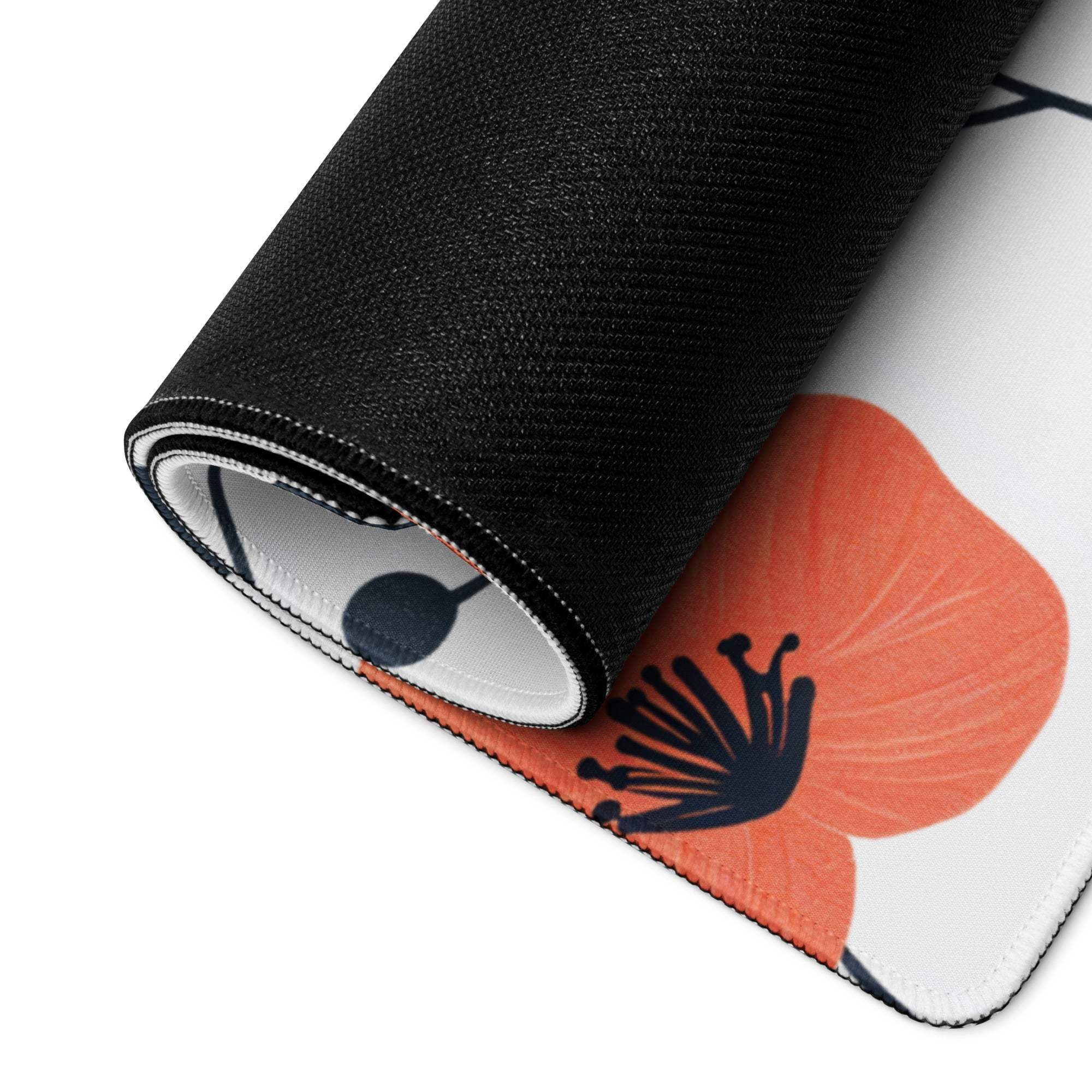 Rolled-up black Floral Style gaming mouse pad with orange poppy print