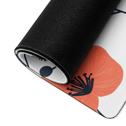 Rolled-up black Floral Style gaming mouse pad with orange poppy print