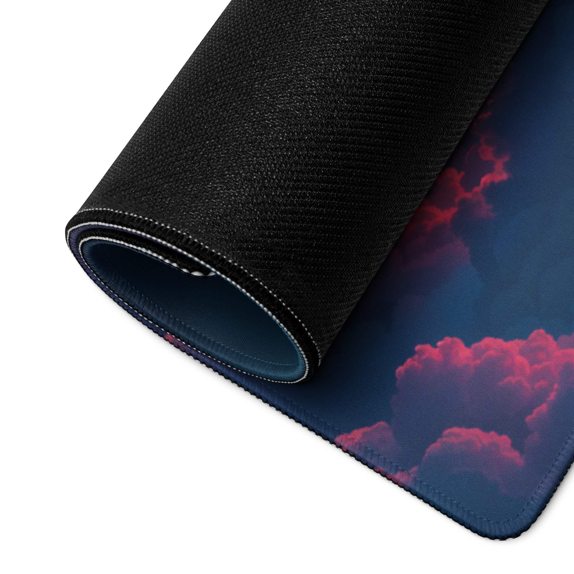 Rolled-up Dreamy Night Sky gaming mouse pad with pink purple clouds
