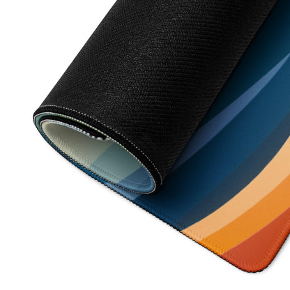 Rolled-up vibrant landscape gaming mouse pad with blue-to-orange gradient