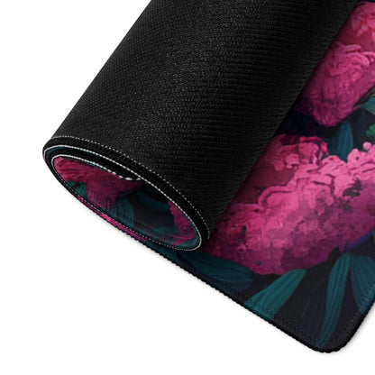 Rolled-up Vibrant Floral Landscape gaming mousepad with pink flowers and stitched edges