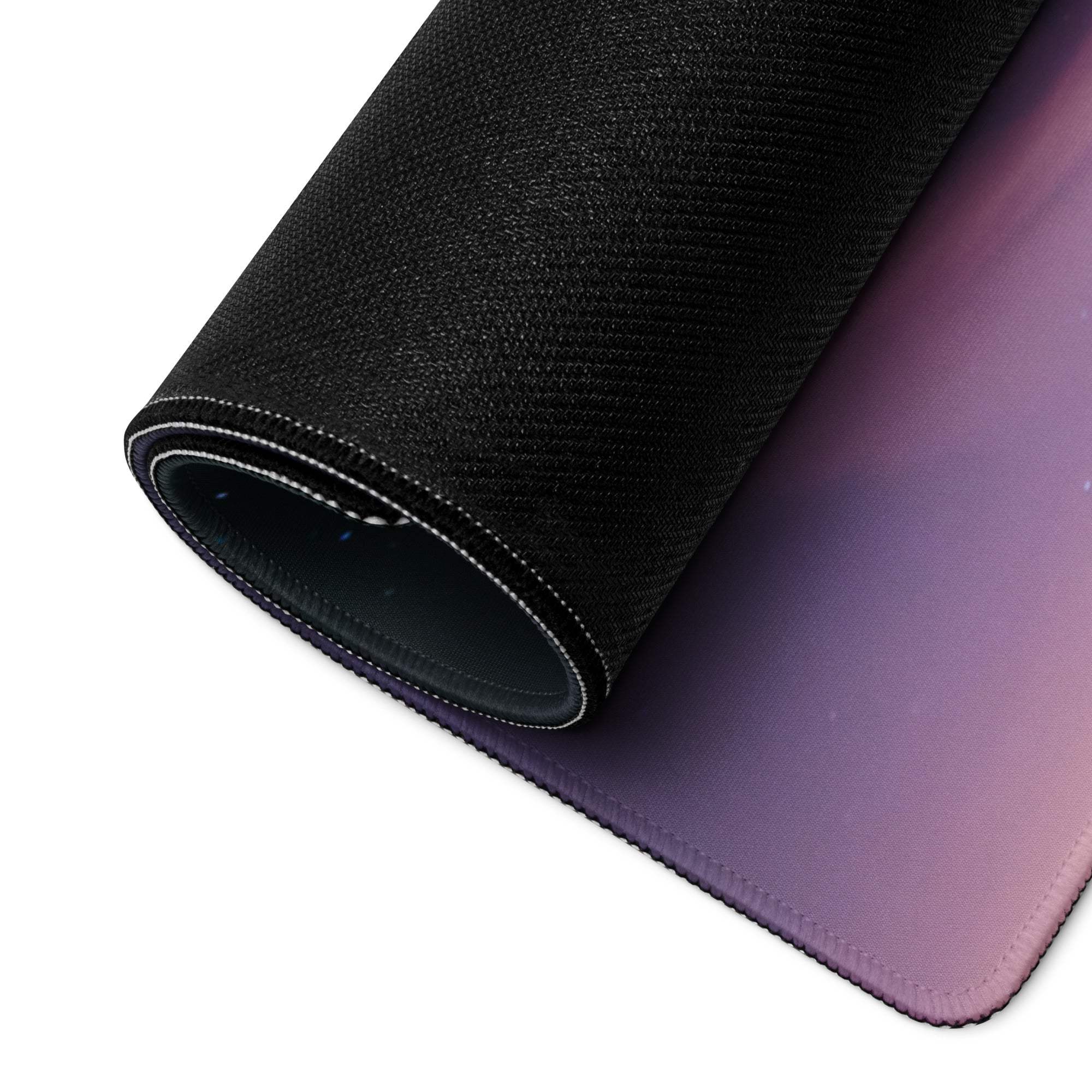 Rolled-up Aurora Night Sky large gaming mouse pad in black purple gradient