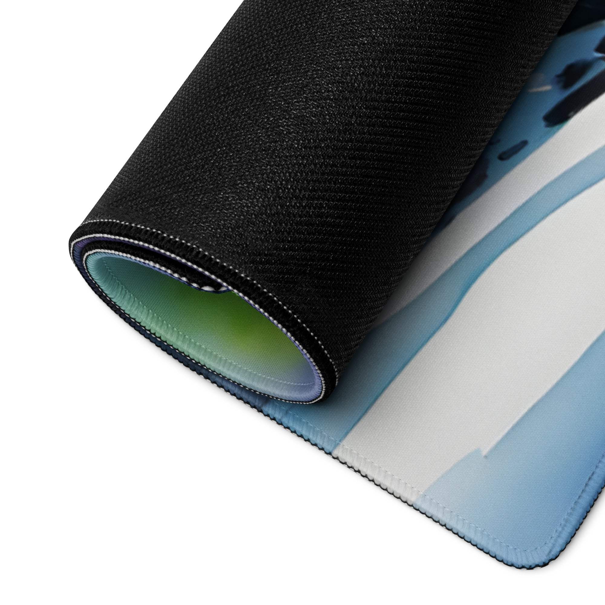 Rolled-up Vibrant Aurora Landscape gaming mouse pad with blue gradient inner surface