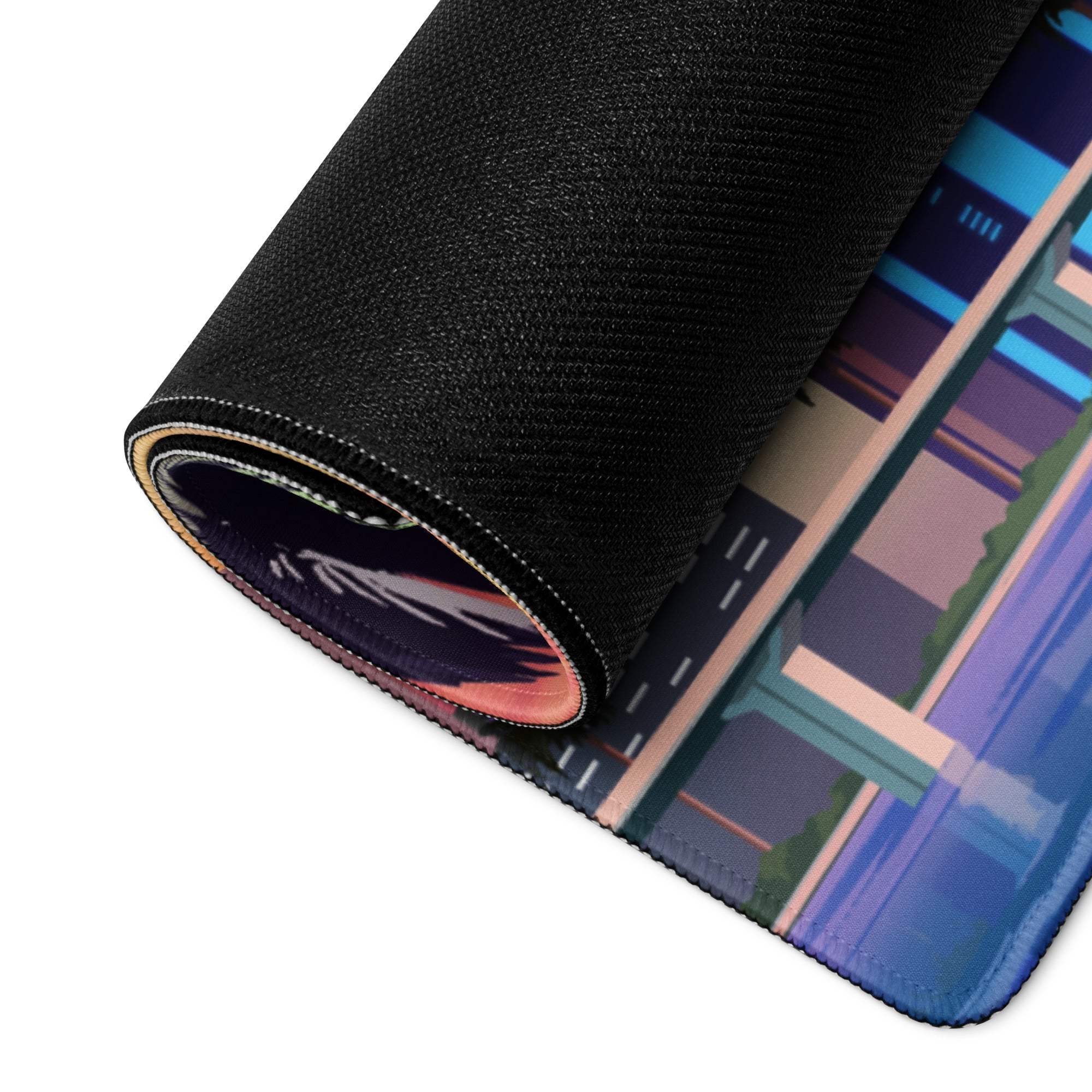 Rolled-up Sunset Cityscape gaming mouse pad with vibrant blue purple cityscape
