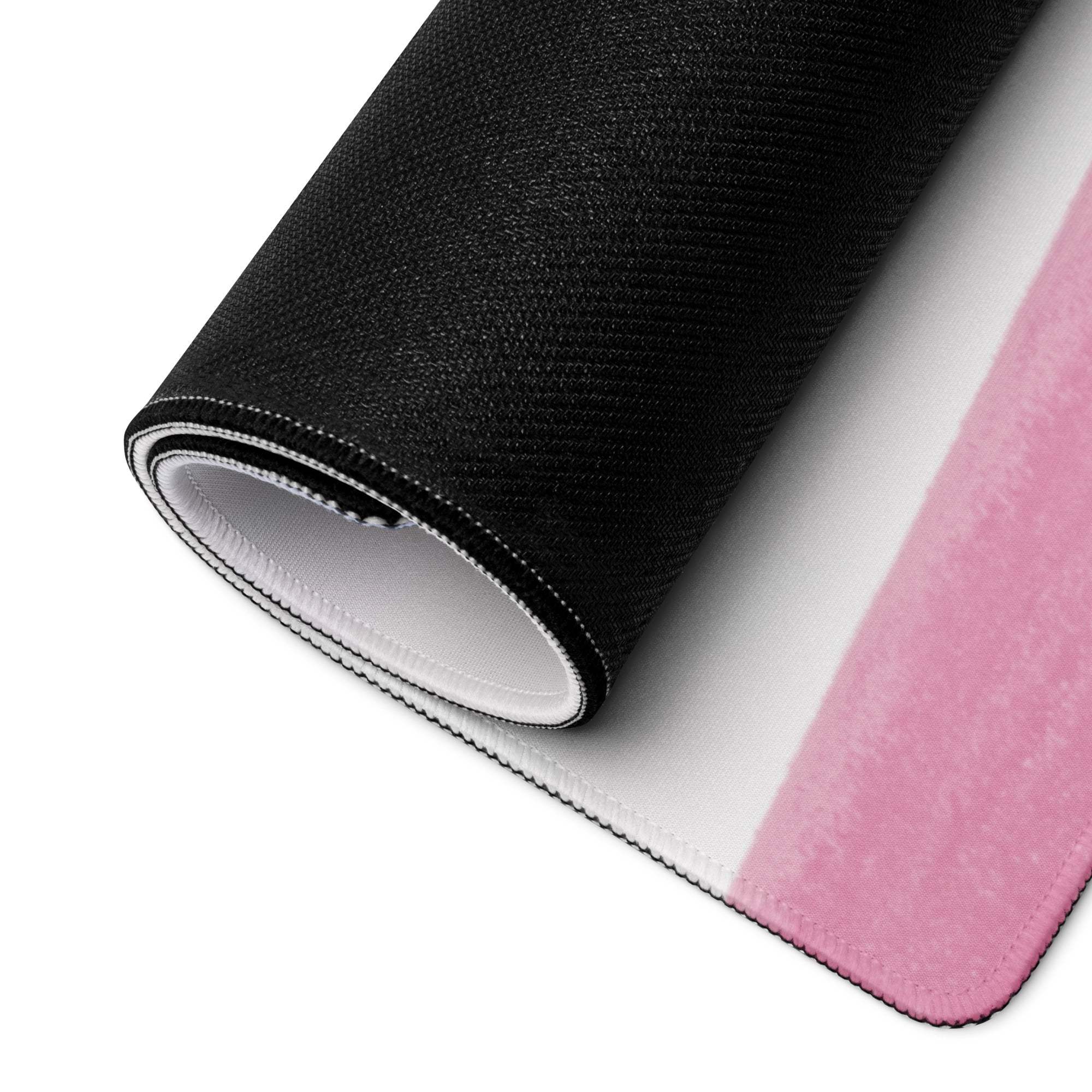 Black and pink gaming mousepad rolled to show white underside