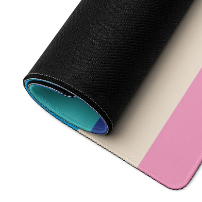Rolled-up abstract geometric gaming mouse pad with black texture, beige-pink gradient and teal lining