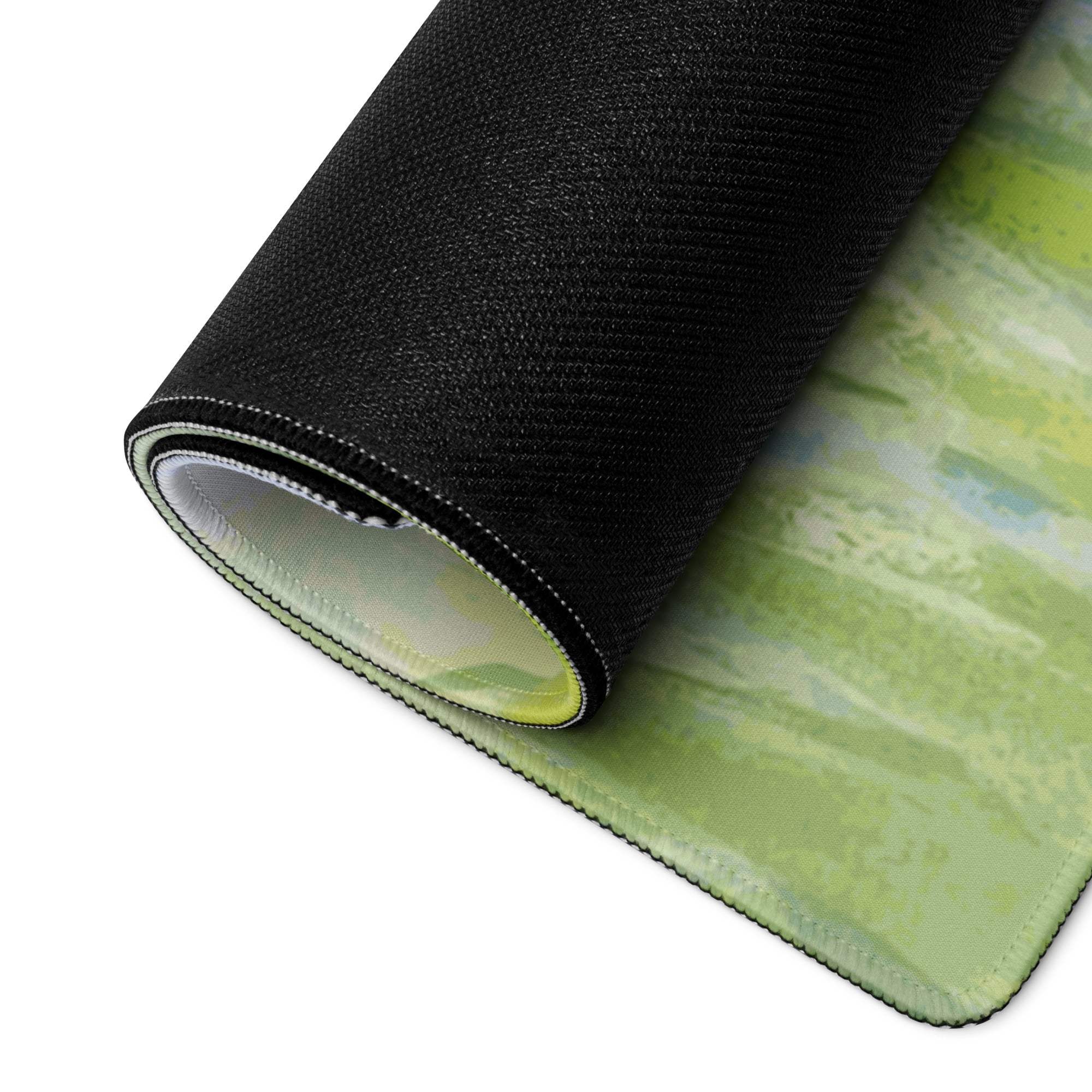 Rolled-up nature-inspired green landscape gaming mouse pad with textured edge