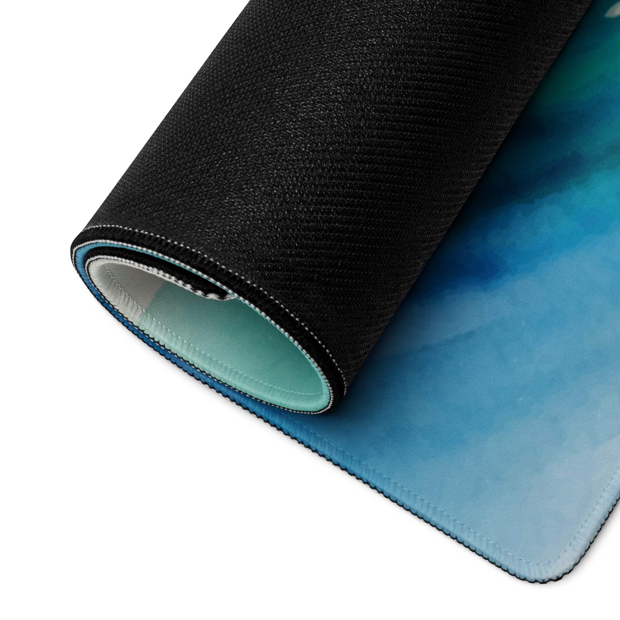 Rolled-up watercolor ocean wave gaming mousepad in deep blue teal
