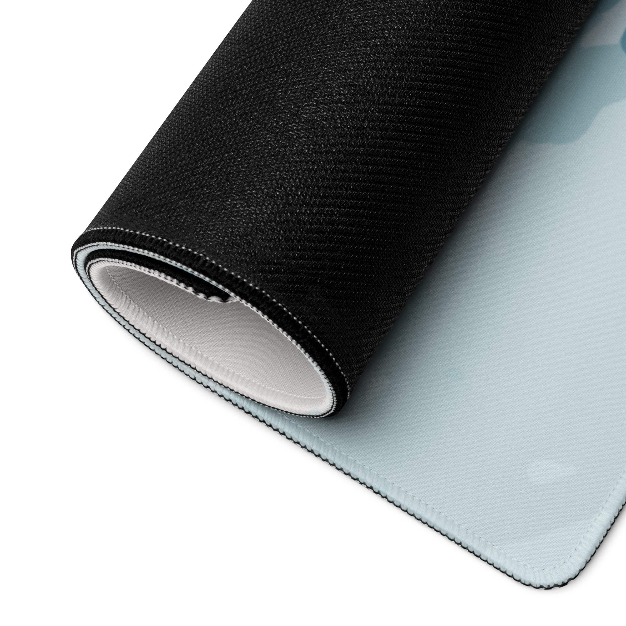 Black textured back of blue floral large gaming mouse pad with white lining