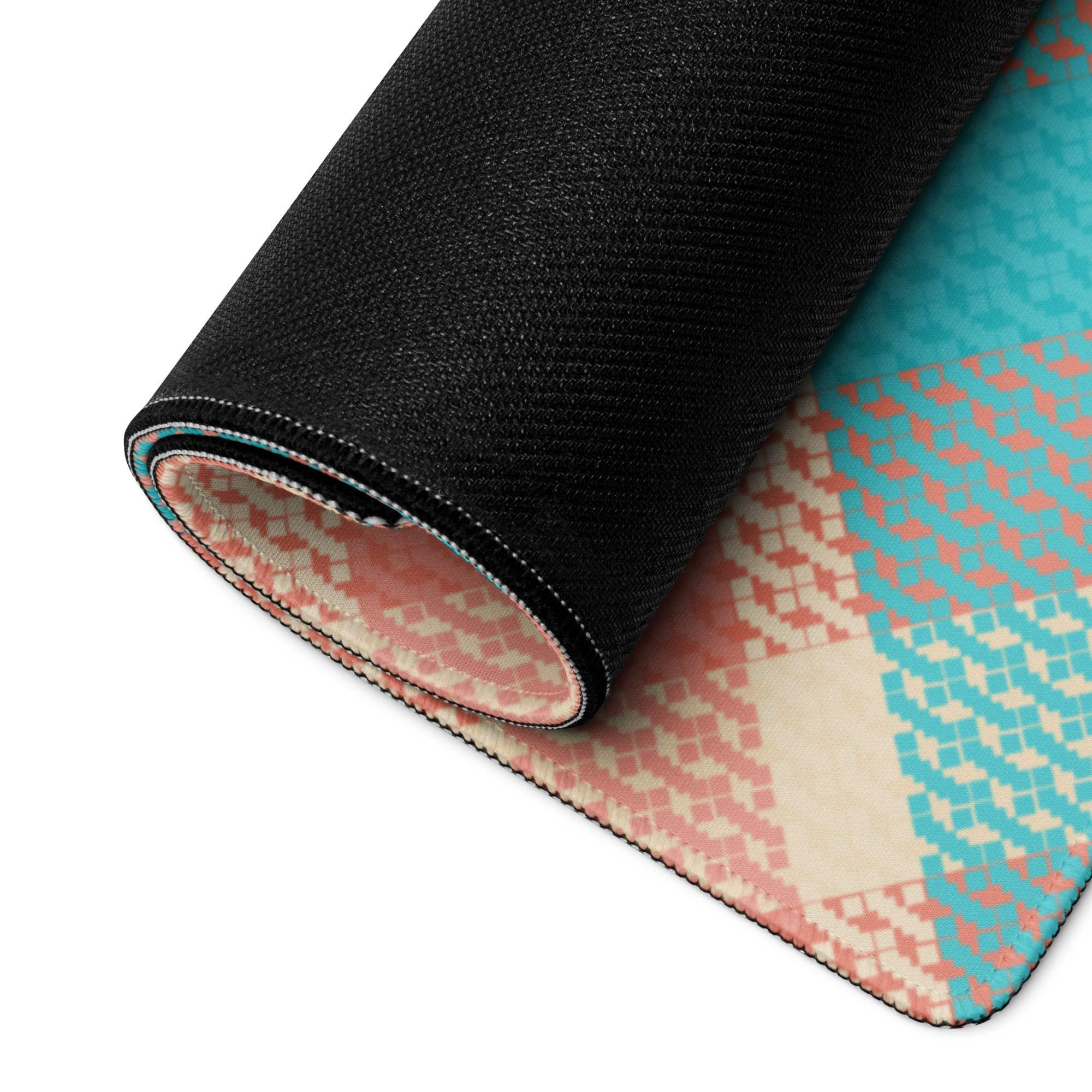 Rolled-up Vibrant Plaid gaming mouse pad in teal, peach, cream geometric pattern