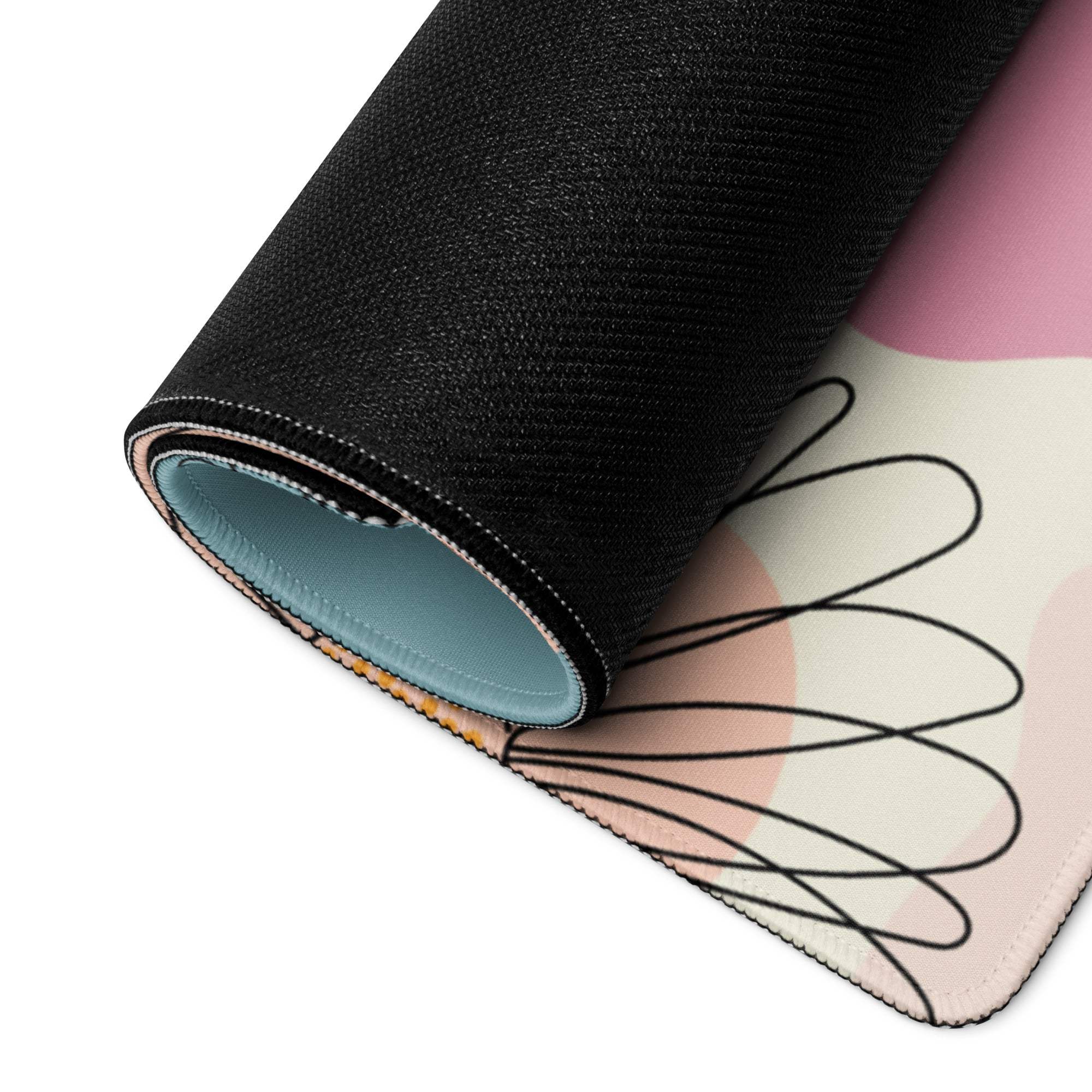 Rolled-up pastel floral abstract gaming mouse pad in soft pink cream with black lines