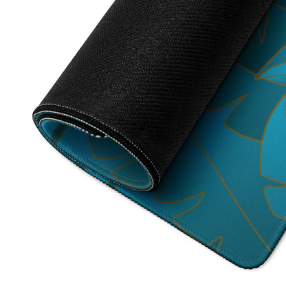 Teal gaming mousepad with gold leaf pattern, black textured edges, non-slip base