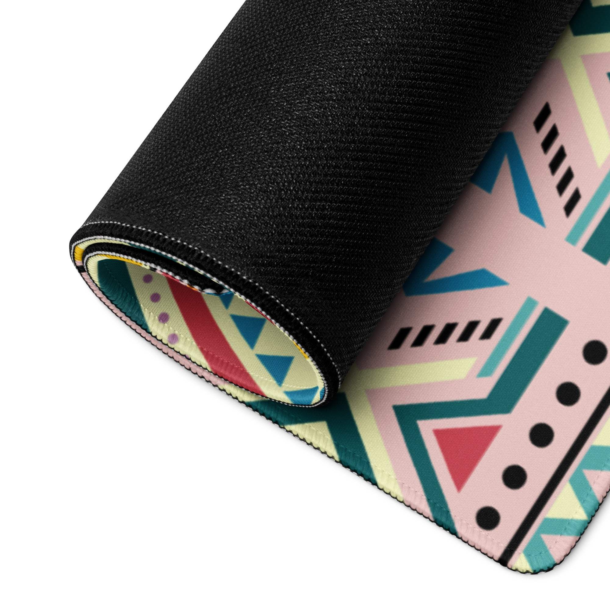 Rolled-up Bohemian Tribal gaming mouse pad with vibrant pink teal pattern