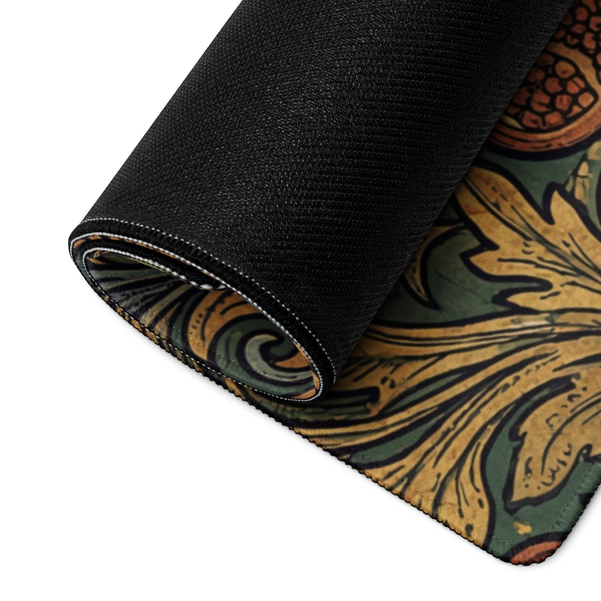 Black ornate floral gaming mouse pad rolled up with gold green design