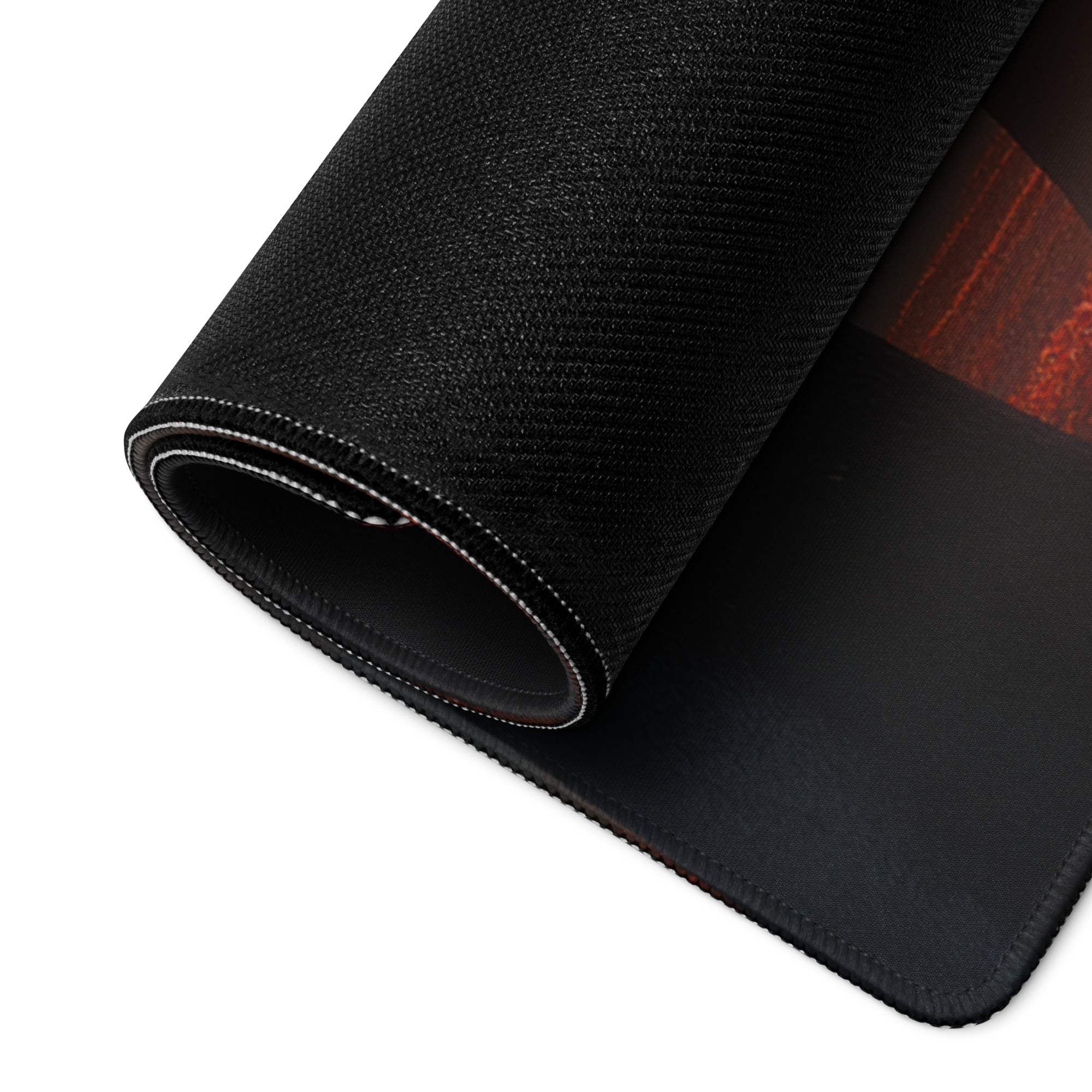 Black textured gaming mousepad with red autumn forest edge, non-slip base