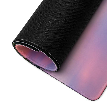 Black textured gaming mouse pad with pink-to-purple gradient, stitched edges, non-slip base