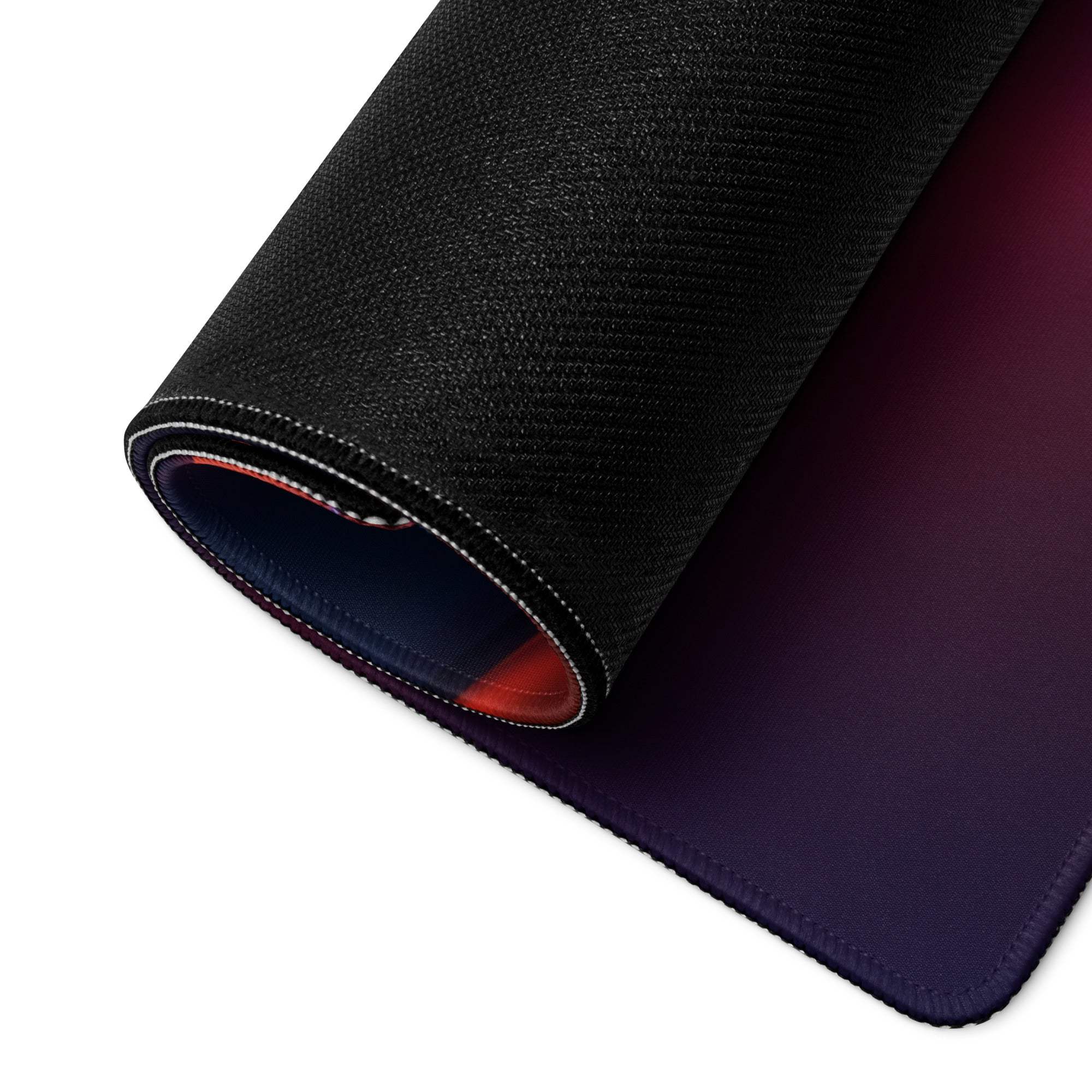 Black textured gaming mousepad back with purple-red gradient underside rolled to reveal layers