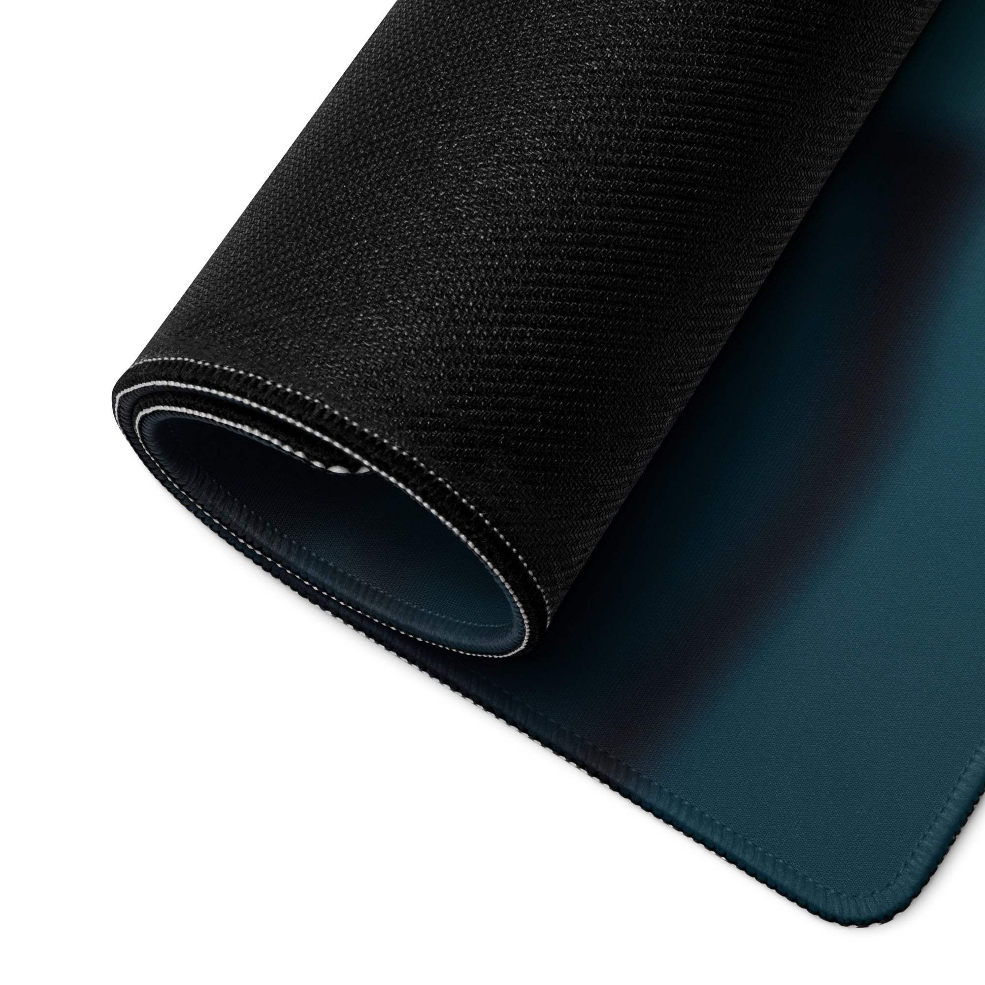 Back of Moody Blue Winter Night Cityscape gaming mouse pad with black texture, teal underside and white stitched edge