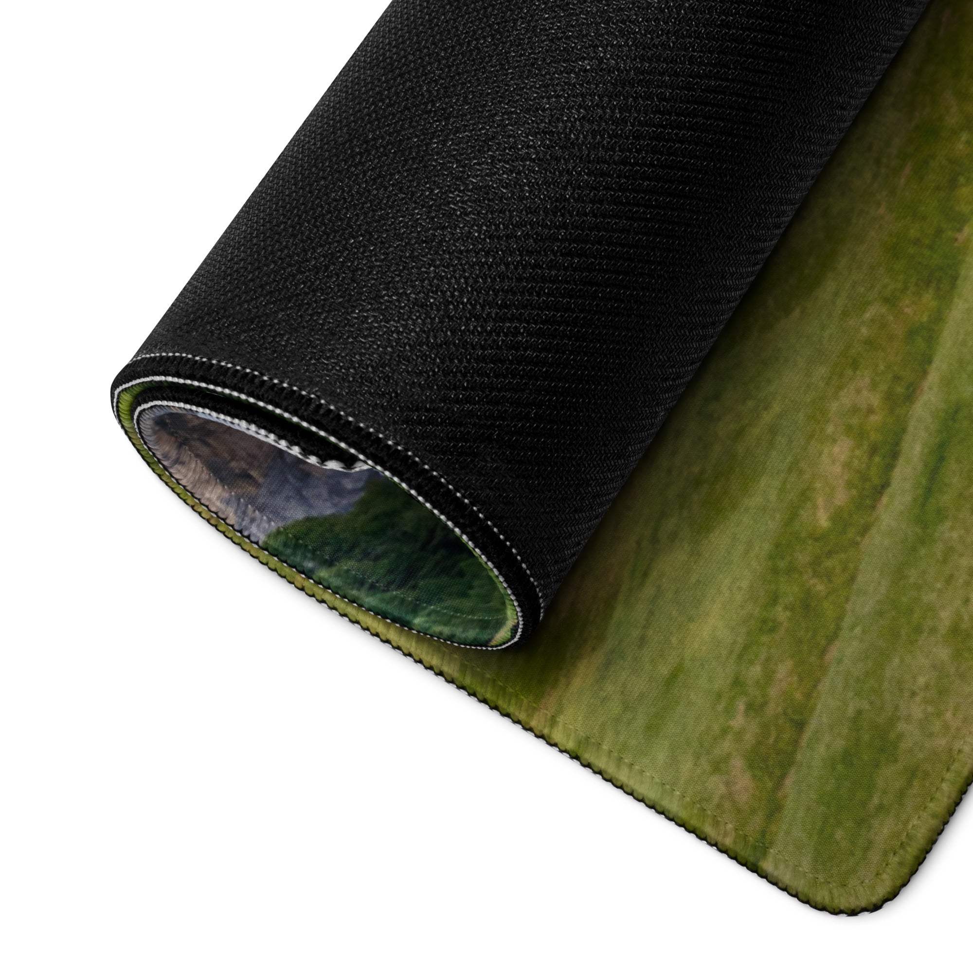 Scenic calm green mountain landscape gaming mouse pad rolled up with black textured backing