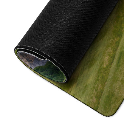 Scenic calm green mountain landscape gaming mouse pad rolled up with black textured backing