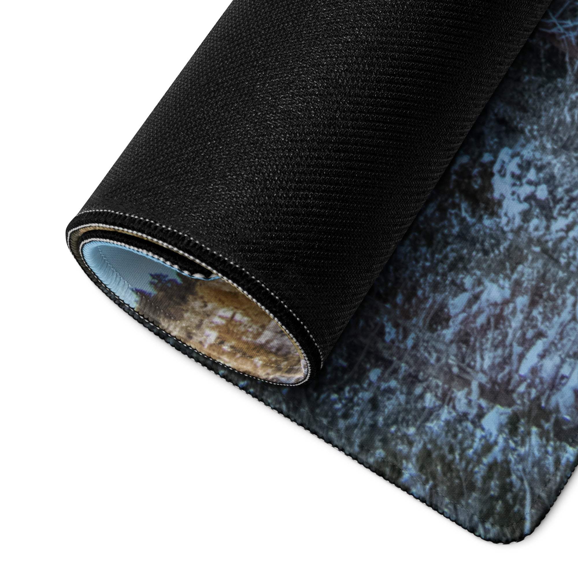 Black textured gaming mousepad with serene winter forest scene, rolled non-slip edge