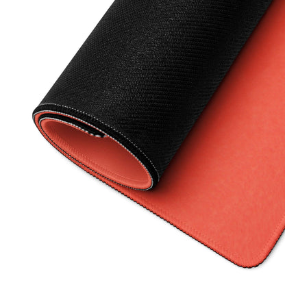 Black and orange gaming mousepad with non-slip base on red backdrop