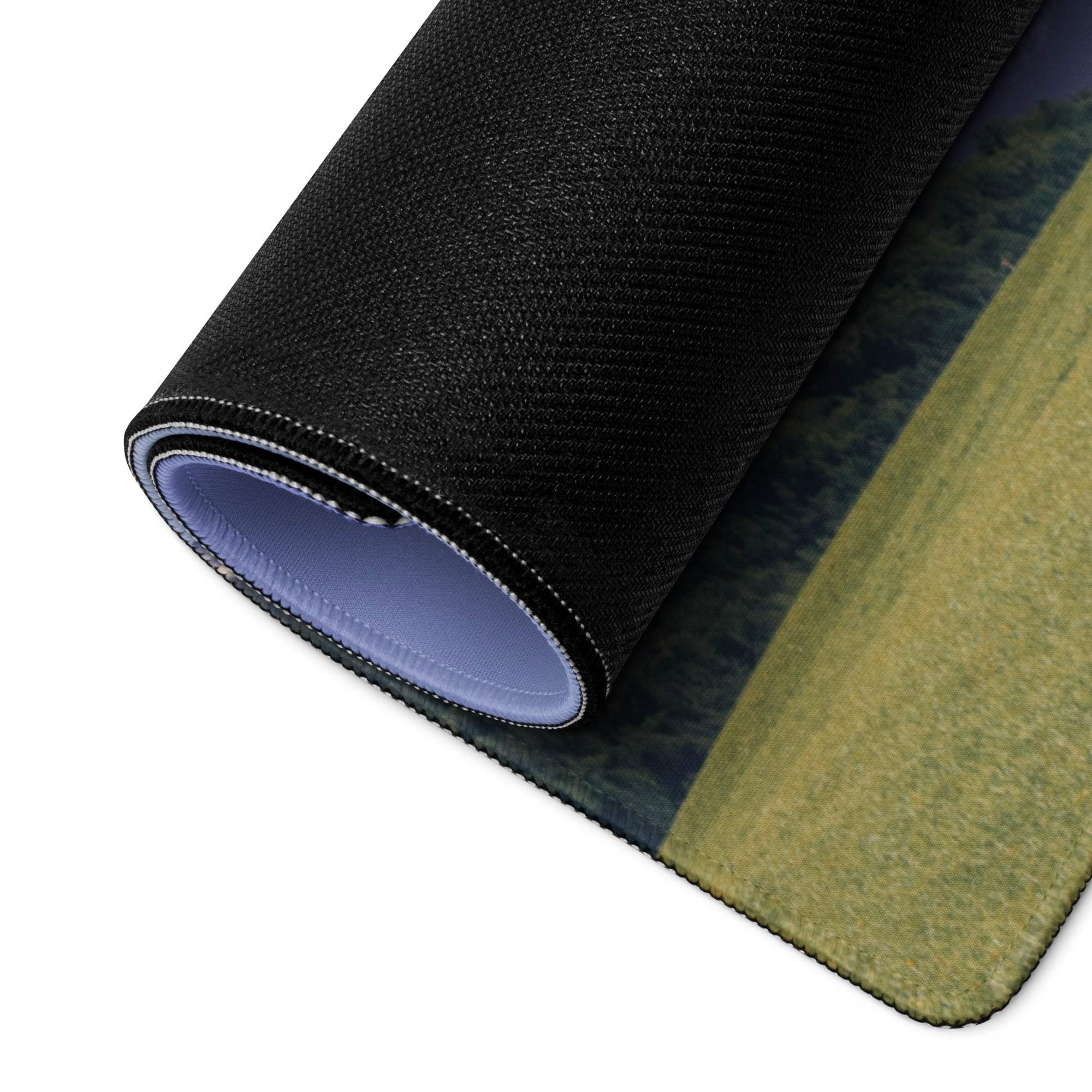 Black textured gaming mousepad with landscape print and purple underside