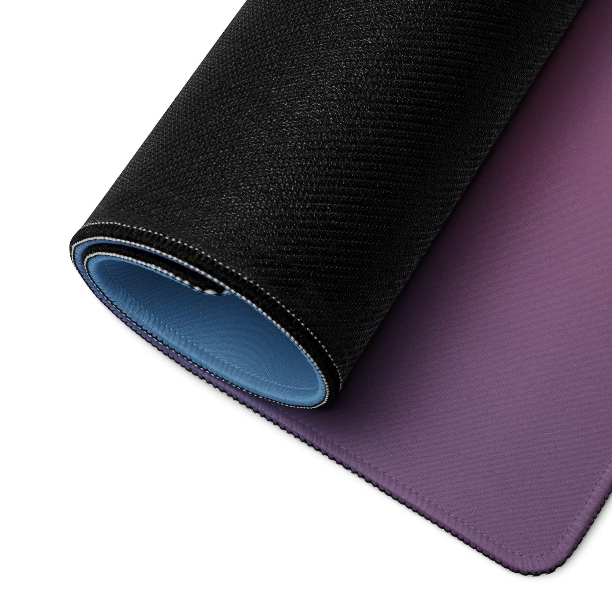 Large vibrant neon gradient gaming mousepad with black purple gradient, textured outer surface, blue inner lining, non-slip base, edge stitching