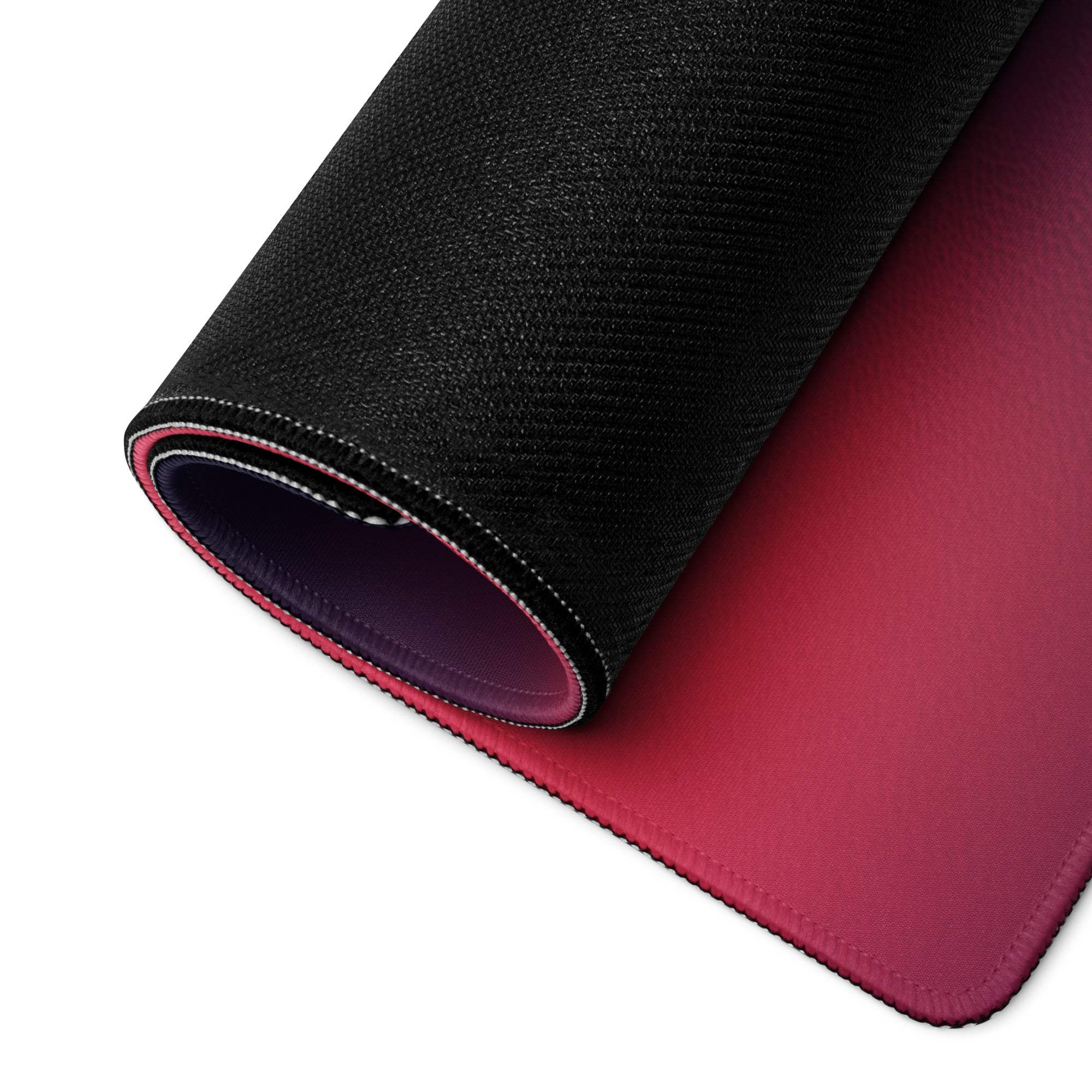 Rolled-up large neon gradient gaming mouse pad with stitched edges