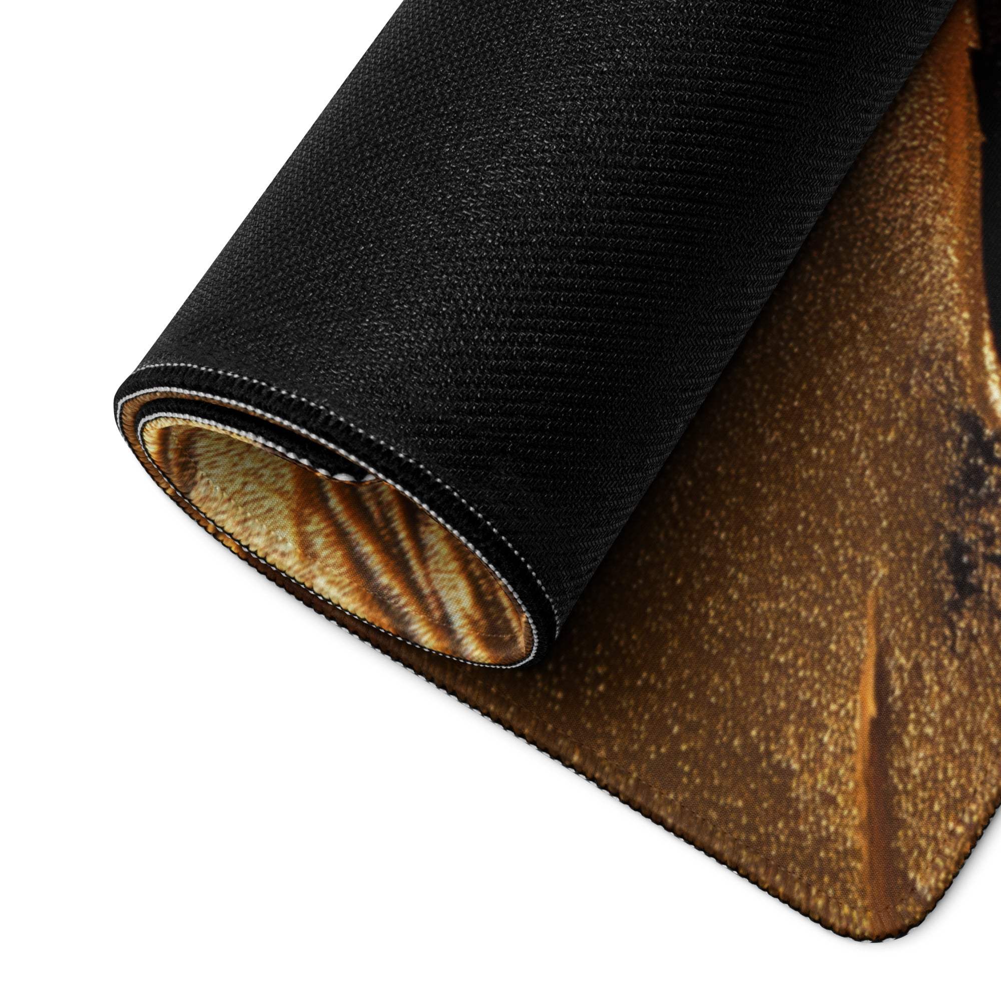 Black textured gaming mousepad with golden glittery unrolled side